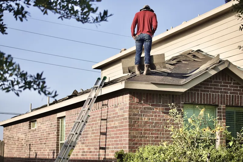 Professional roofer working on a residential roof in Melville Village